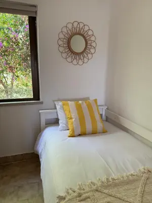 a bedroom with a bed with a mirror on the wall at Lemon Beach House - São Rafael in Albufeira