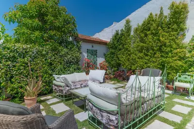 a backyard with chairs and a couch and trees at Perfect To Relax in Algoz