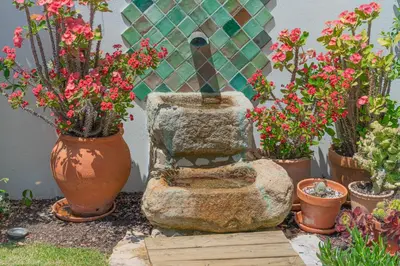 a flower garden with a toilet and potted plants at Perfect To Relax in Algoz