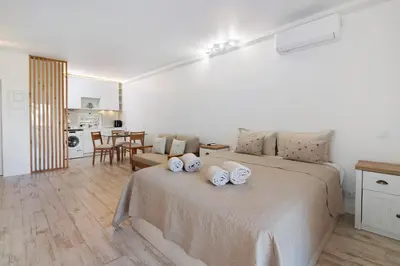 a bedroom with a bed with two pillows on it at White Studio and Terrace in Albufeira