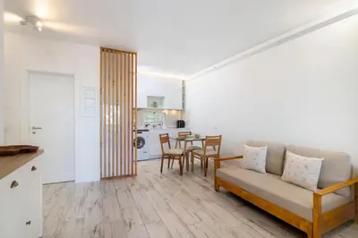 a living room with a couch and a table at White Studio and Terrace in Albufeira