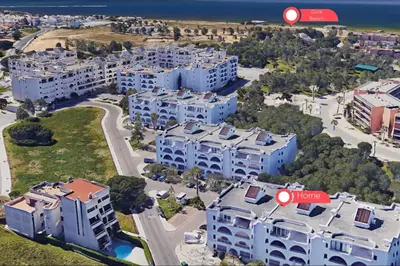 an aerial view of an apartment complex with two red arrows at #335 Recanto do Manaca by Home Holidays in Guia