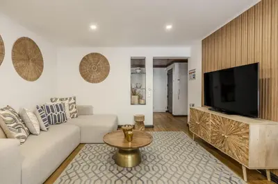 a large white bed in a room with blue chairs at #335 Recanto do Manaca by Home Holidays in Guia