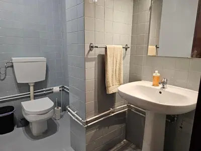 a bathroom with a white toilet and a sink at Blife Portugalya - private rooms at Santantonya 2nd floor in Faro
