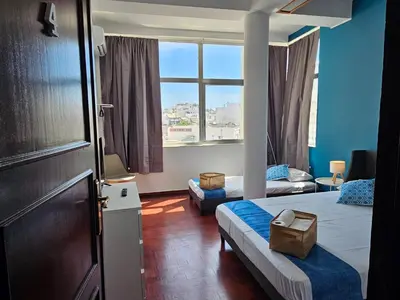 a hotel room with two beds and a window at Blife Portugalya - private rooms at Santantonya 2nd floor in Faro