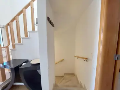 a bathroom with a toilet next to a staircase at Vilapeti by SAPvillas in Quarteira