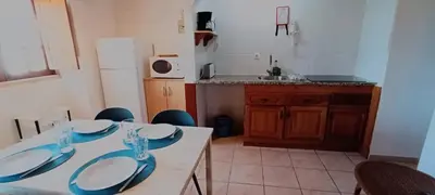 a kitchen with a table with blue and white plates on it at Quinta do Lagar - 01 in Albufeira