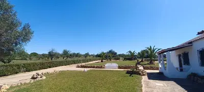 a house with a garden next to a building at Quinta do Lagar - 03 in Albufeira