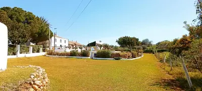 a large yard with a house in the background at Quinta do Lagar - 04 in Albufeira