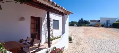 a white building with a bench on the side of it at Quinta do Lagar - 04 in Albufeira
