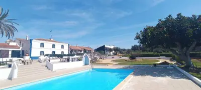 a large swimming pool in front of a house at Quinta do Lagar - 05 in Albufeira