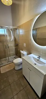 a bathroom with a toilet and a shower and a sink at Quinta do Lagar - 05 in Albufeira