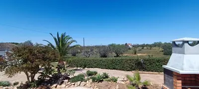 a view of a garden with trees and a building at Quinta do Lagar - 06 in Albufeira