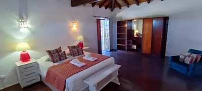 a bedroom with a bed with a red blanket at Quinta do Lagar - 08 in Albufeira