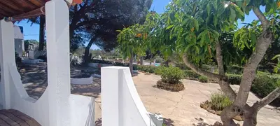 a white fence in a yard with a tree at Quinta do Lagar - 08 in Albufeira
