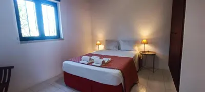 a bedroom with a bed with two towels on it at Quinta do Lagar - 09 in Albufeira