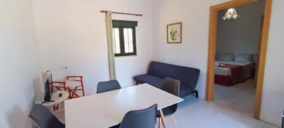 a room with a table and chairs and a bed at Quinta do Lagar - 09 in Albufeira