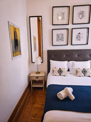 a bedroom with a bed with two towels on it at The Central Faro in Faro