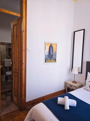 a bedroom with a bed and a chandelier at The Central Faro in Faro