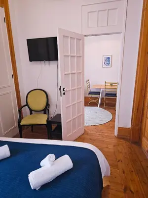 a bedroom with a bed with two crosses on it at The Central Faro in Faro