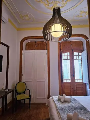 a bathroom with a shower and a tub and a sink at The Central Faro in Faro