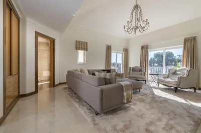 a living room with a couch and a chandelier at V4 Duplex Quinta do Lago Sal in Quinta do Lago