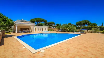 a large swimming pool in front of a house at V4 Duplex Quinta do Lago Sal in Quinta do Lago