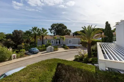 a house with a car parked in a driveway at V4 Duplex Quinta do Lago Sal in Quinta do Lago