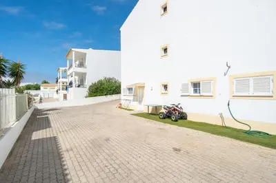 a motorcycle parked next to a white building at Casa Biamar in Albufeira