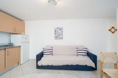 a kitchen with a couch with two pillows on it at Casa Biamar in Albufeira