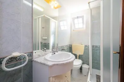 a bathroom with a sink and a toilet and a shower at Casa Biamar in Albufeira