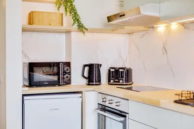 a kitchen with a counter top with appliances on it at Brisa Algarvia 2 in Faro