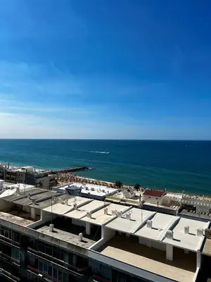 a view of the ocean from the roof of a building at Ocean View Apartment Steps to Beach Vil15m Faro25m in Quarteira
