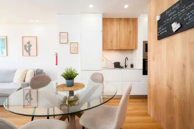 a living room with a glass table and a couch at Ocean View Apartment Steps to Beach Vil15m Faro25m in Quarteira