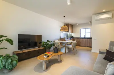 a living room with a large television and a table at Casa Alonso 2 Bedroom Apartment with Pool in Albufeira