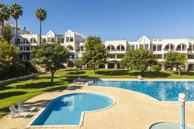 an empty swimming pool in front of a large building at Casa Alonso 2 Bedroom Apartment with Pool in Albufeira