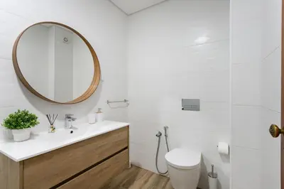 a bathroom with a sink and a toilet and a mirror at SunnyQuarters WalktoBeach 2BR AC
