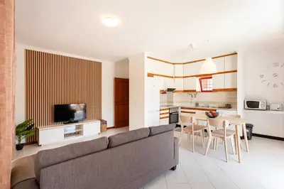 a living room with a couch and a table at SunnyQuarters WalktoBeach 2BR AC