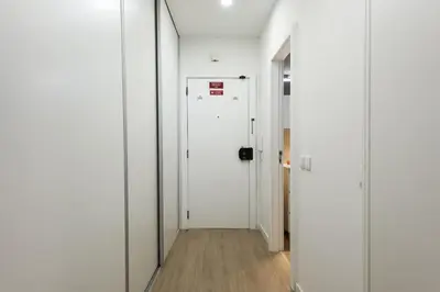 a hallway with white walls and a white door at Maya Vilamoura - City center by HD PROPERTIES in Vilamoura