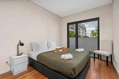 a bedroom with a large bed and a window at Rooftop Pools & Balcony Haven by HostWise in Faro