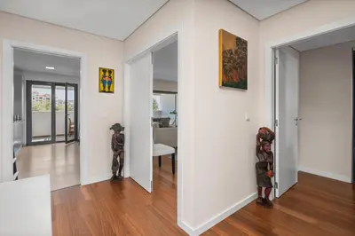 two sculptures are standing in a living room at Rooftop Pools & Balcony Haven by HostWise in Faro