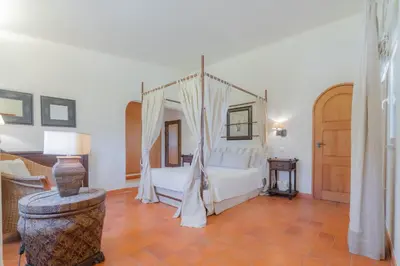 a bedroom with a bed with a canopy at Golf&Mar By Garvetur Villas in Loulé