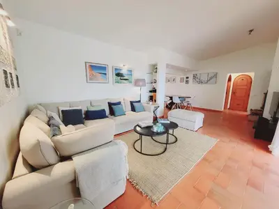 a living room with a white couch and a table at Golf&Mar By Garvetur Villas in Loulé