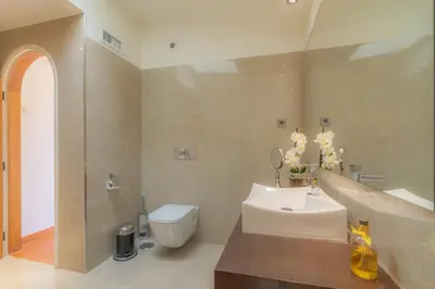 a bathroom with a white toilet and a sink at Golf&Mar By Garvetur Villas in Loulé