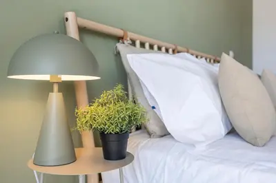 a bed with a lamp and potted plants on it at Casa A in Olhos de Água