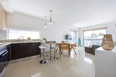 a kitchen with a sink and a table with chairs at Casa A in Olhos de Água