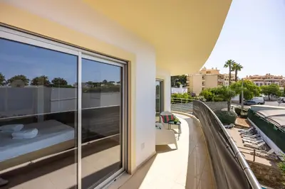 a balcony with a bed and a view of a city at Casa A in Olhos de Água