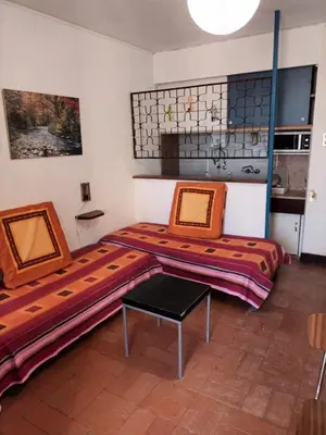a room with two beds and a table in it at Apartamento Alto de Abufeira in Albufeira