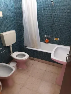 a bathroom with a toilet and a sink and a tub at Apartamento Alto de Abufeira in Albufeira