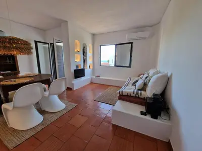 a living room with a couch and a table at Incrível T1 na praia da Oura in Albufeira